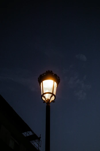 a lamp post sitting on the side of a street