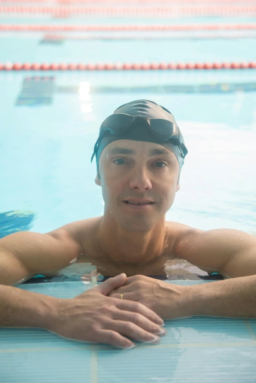 a man in a hat is in the swimming pool