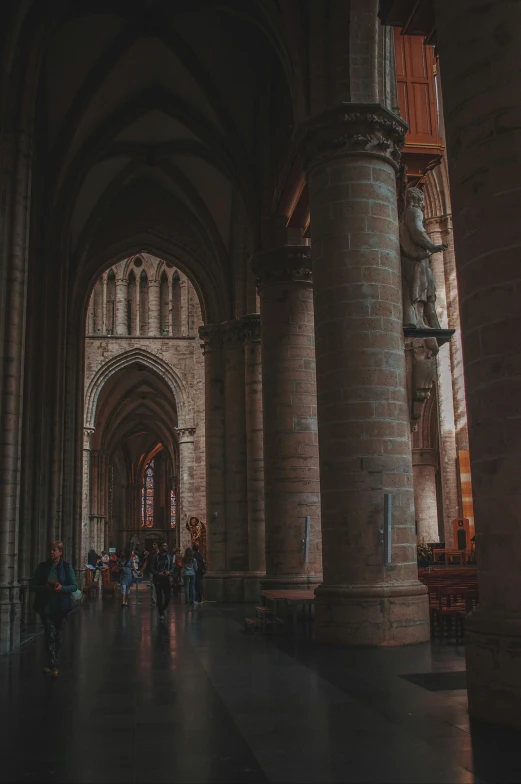 two stone pillars with statues inside an old cathedral