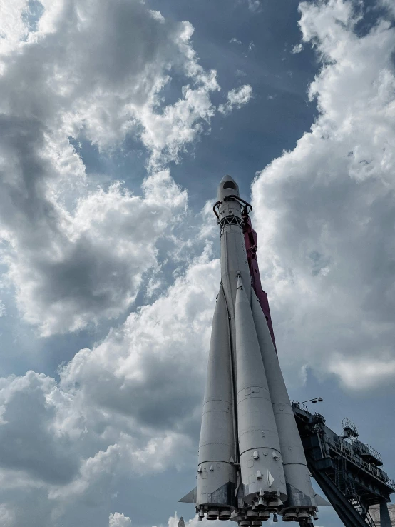 a large white and red model plane under a cloudy sky