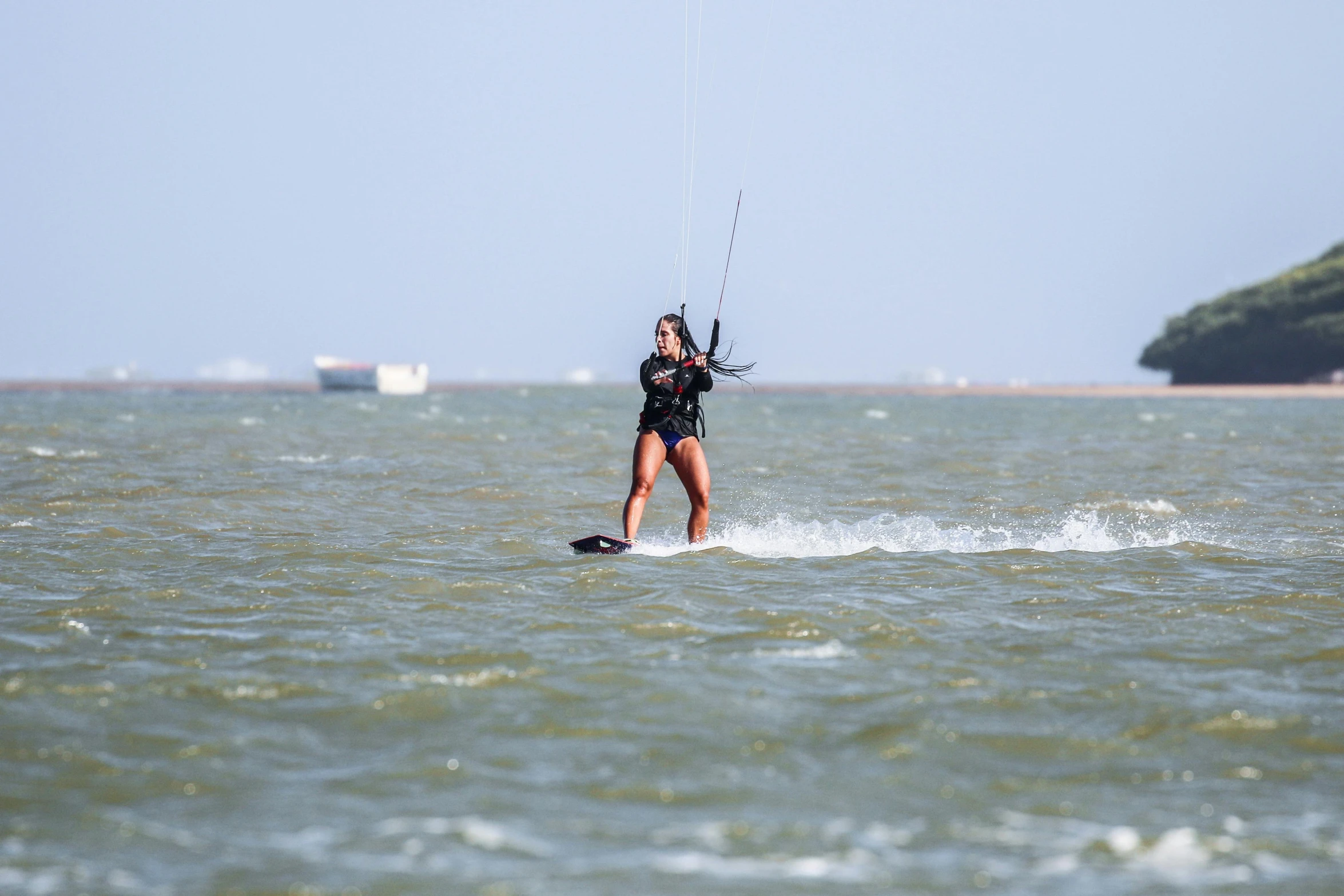 a person water skiing and holding onto some ropes