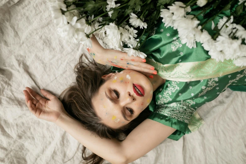 a woman laying on her back in a dress with decorations