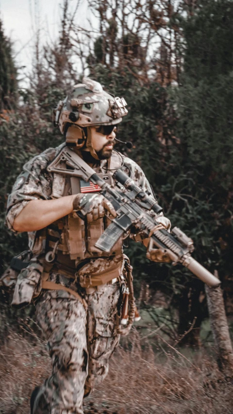 a person is holding a machine gun in the forest