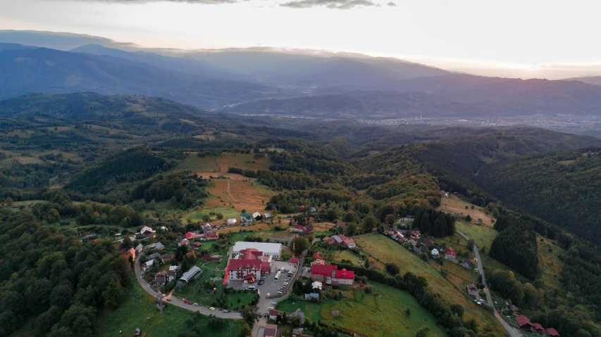 a scenic po of a valley, trees and homes