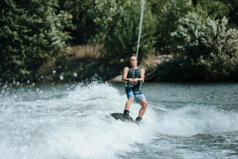 a man waterskiing holding a rope behind him