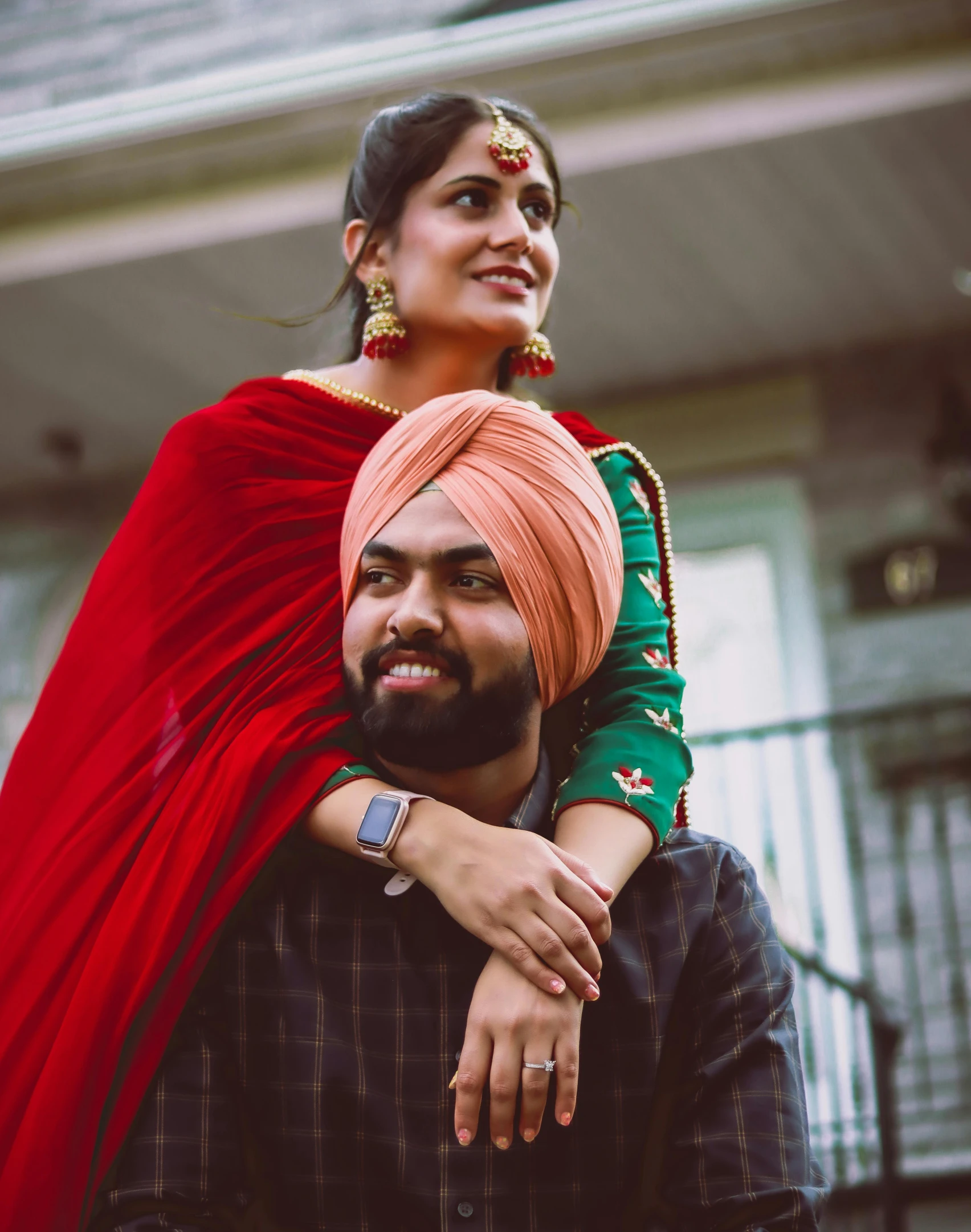 an indian couple standing in front of a building