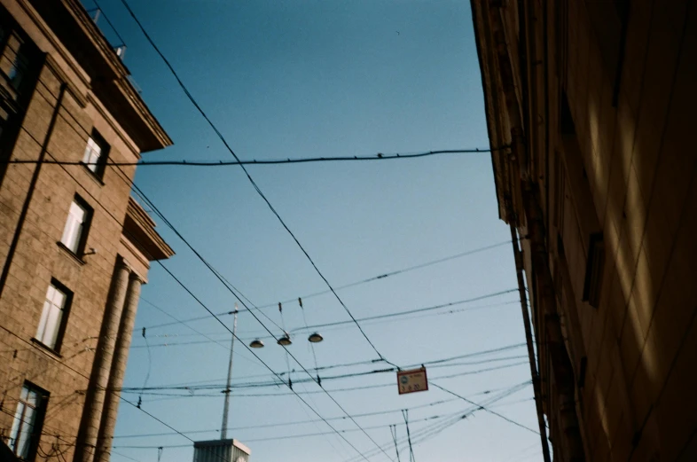 telephone wires over a city street near buildings