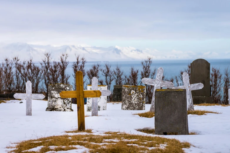 several crosses, standing in the snow on a snowy surface