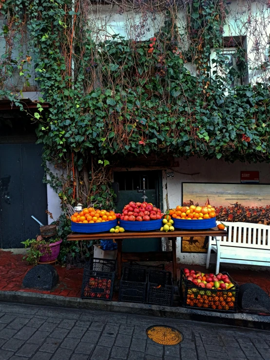 there is a produce stand with fruit outside