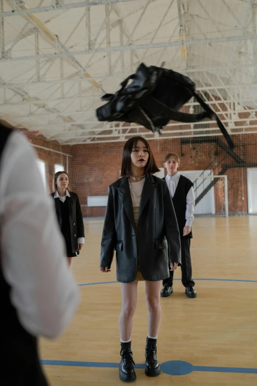 a girl in an empty building with a dragon kite behind her