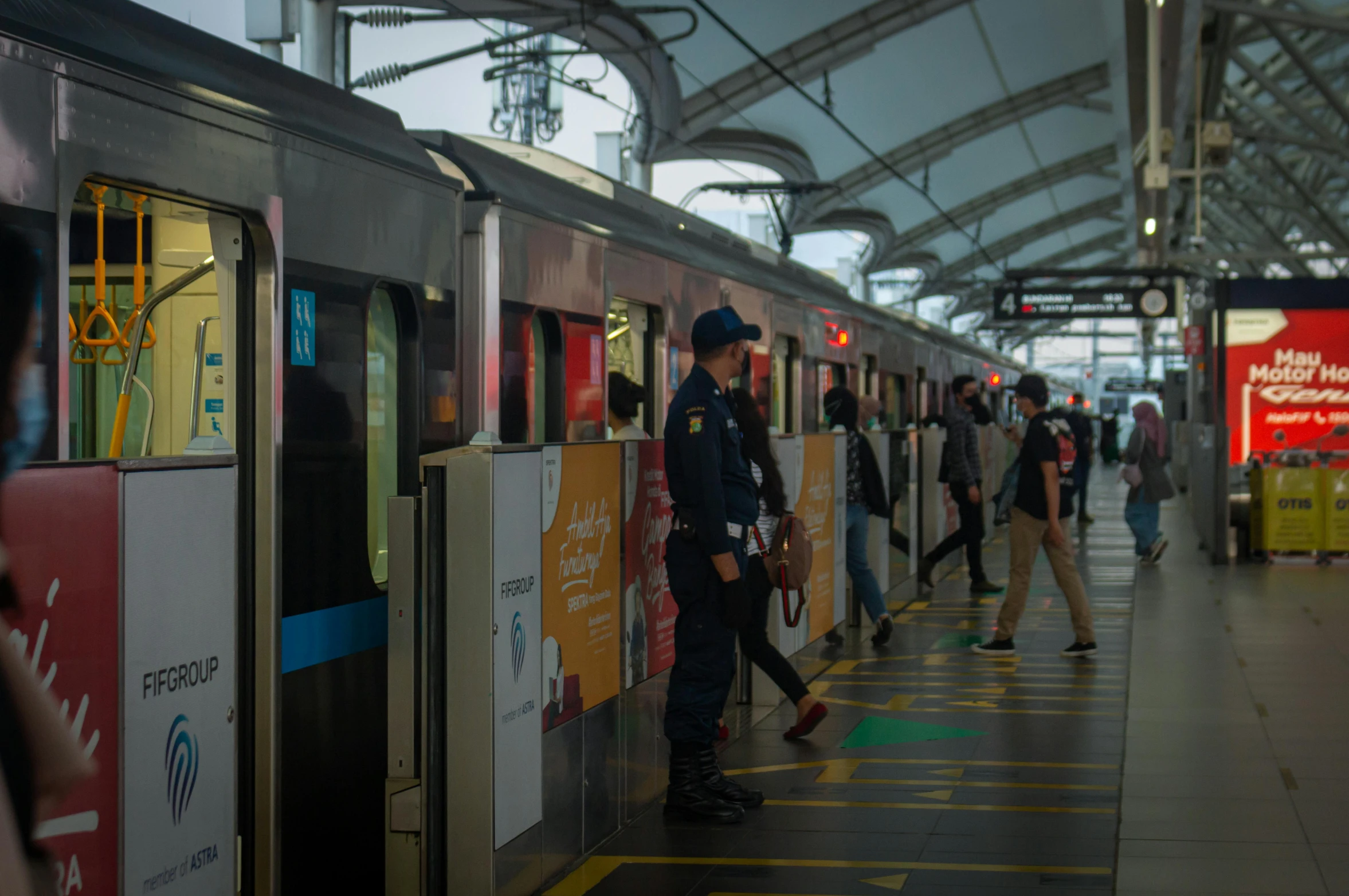 a man in a police uniform walking along a platform