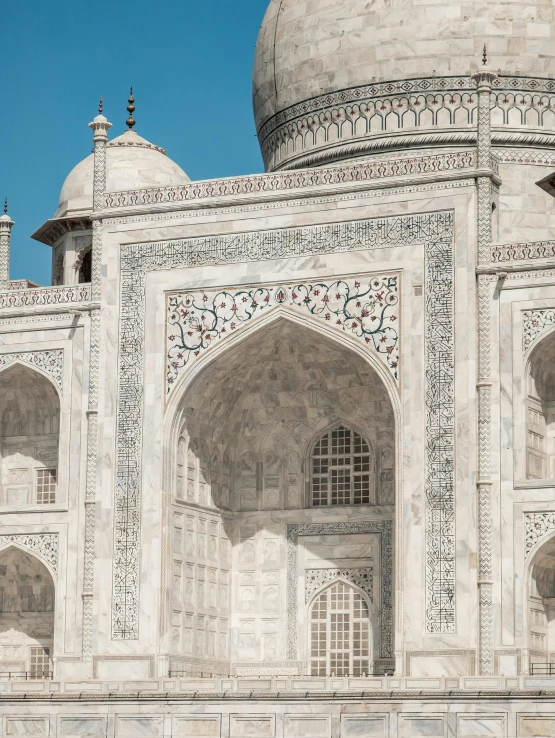 an ornate white building is shown against a blue sky