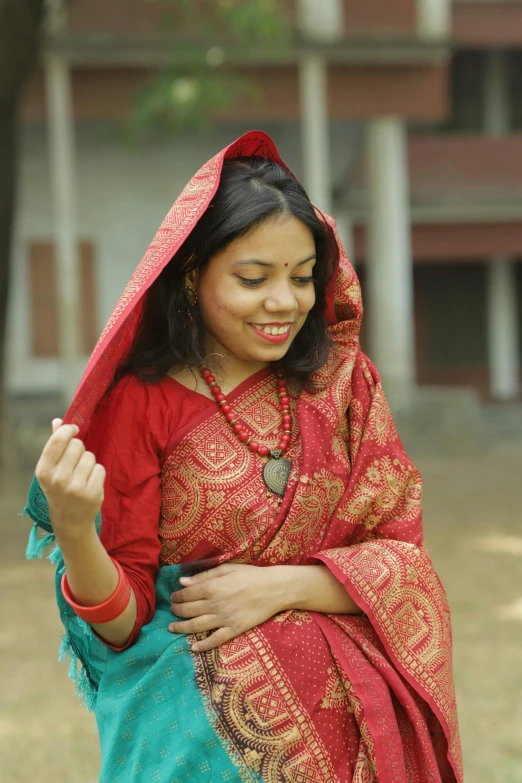 a lady wearing a red and green sari