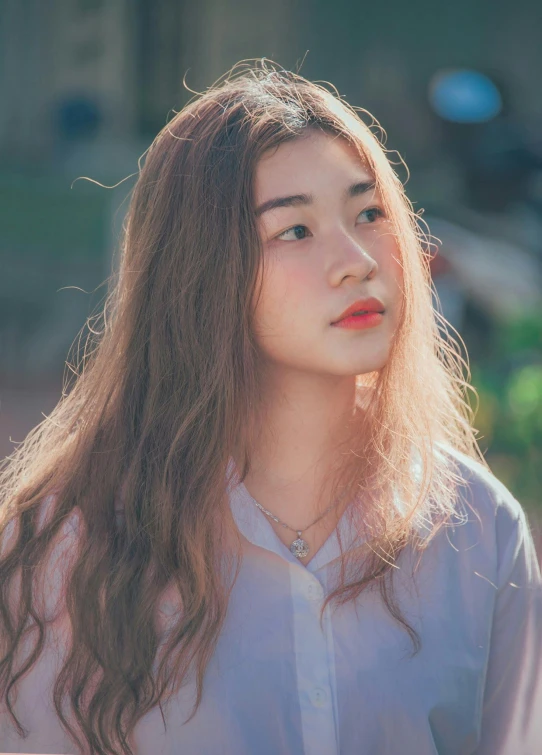 a woman with long hair and a white shirt