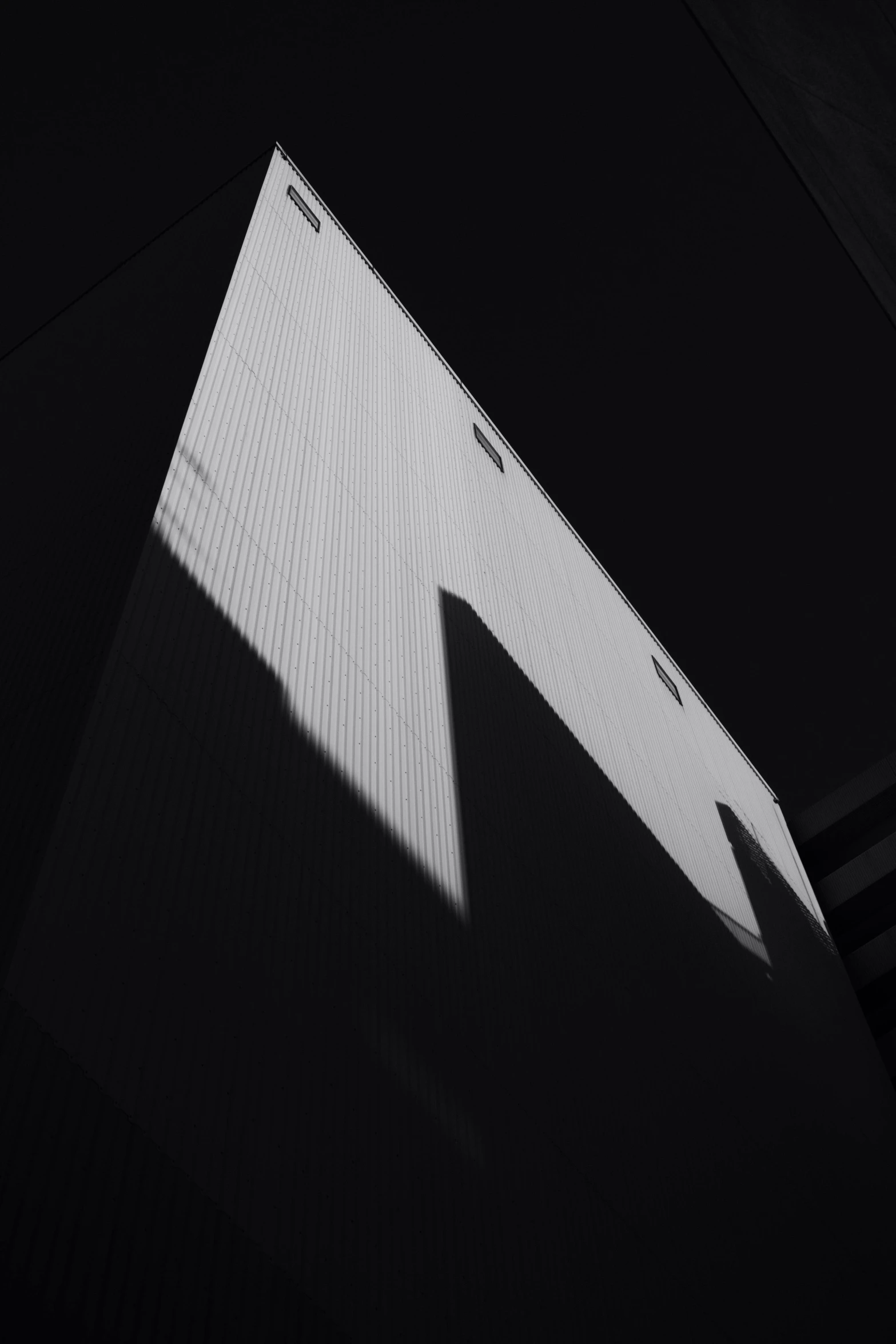 the shadow of a building is shown against the black backdrop