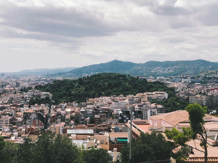 a scenic view of an urban area with mountains in the background