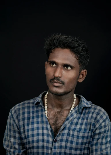 a man wearing pearls on a necklace