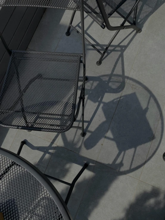 several steel tables sit on concrete pavement