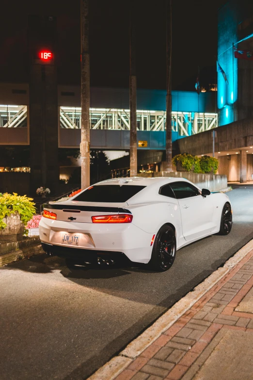 a white car sitting in front of a building