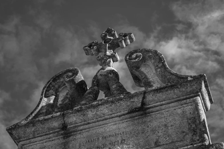 a cross sitting on top of a stone structure