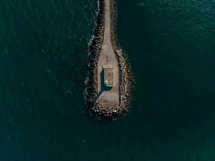 an aerial view of an airplane landing pad in the ocean