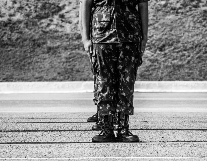 a man wearing an overall while standing in front of mountains