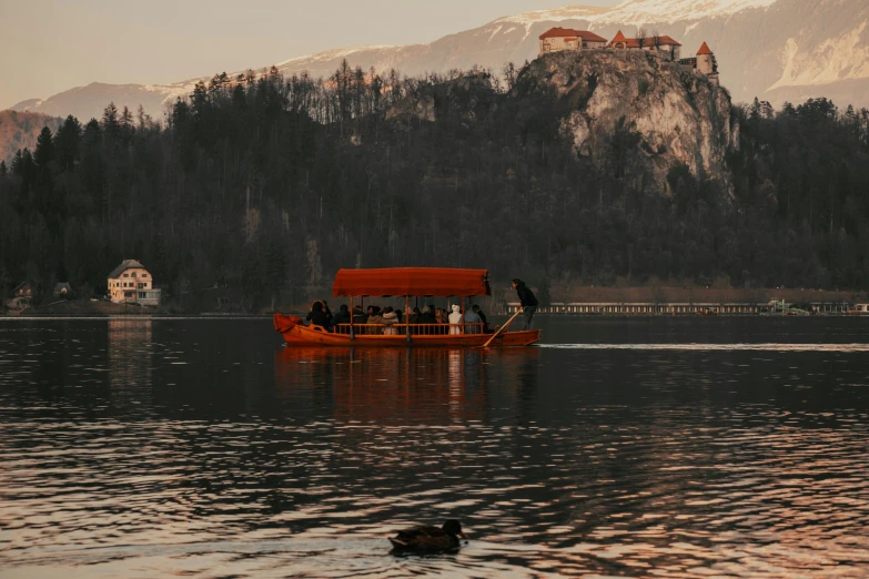 a boat with people on it riding in the water