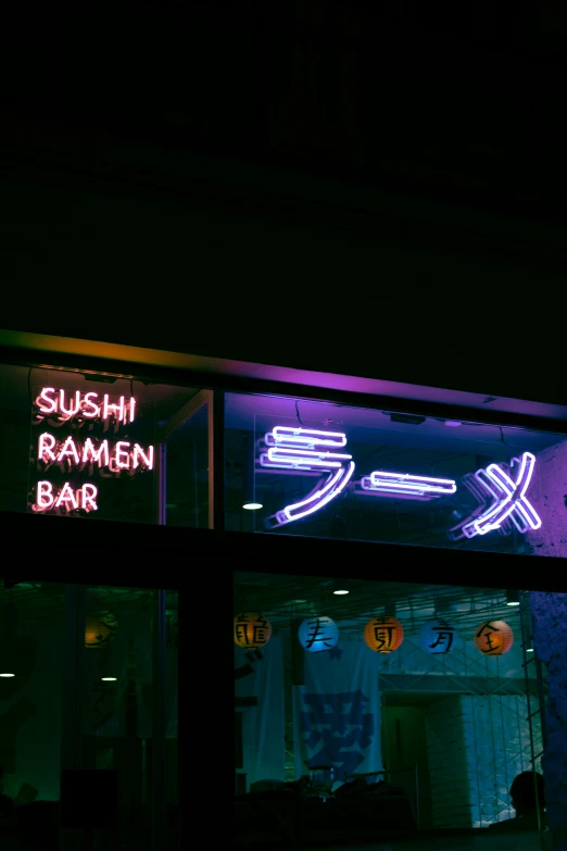 a restaurant sign lit up at night with neon lights