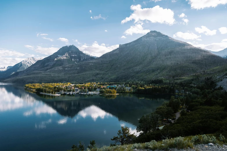 mountains are reflected in the blue lake of water