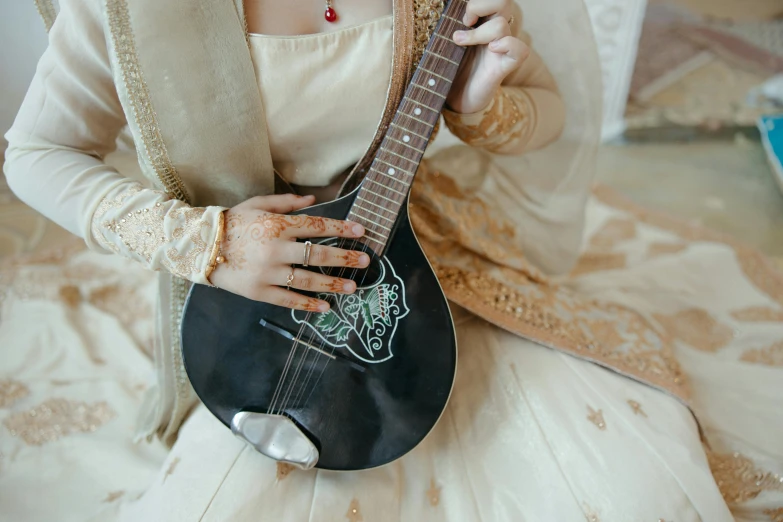 a close up of a person holding an electric guitar