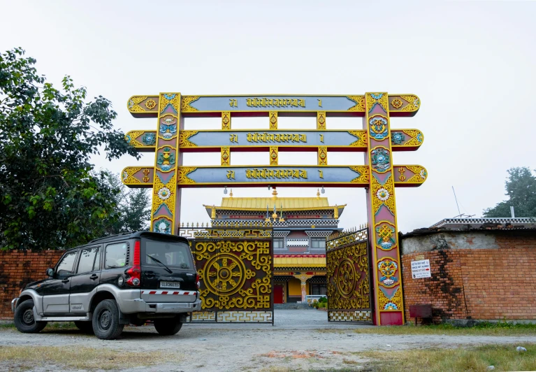 the vehicle is parked under an elaborate archway