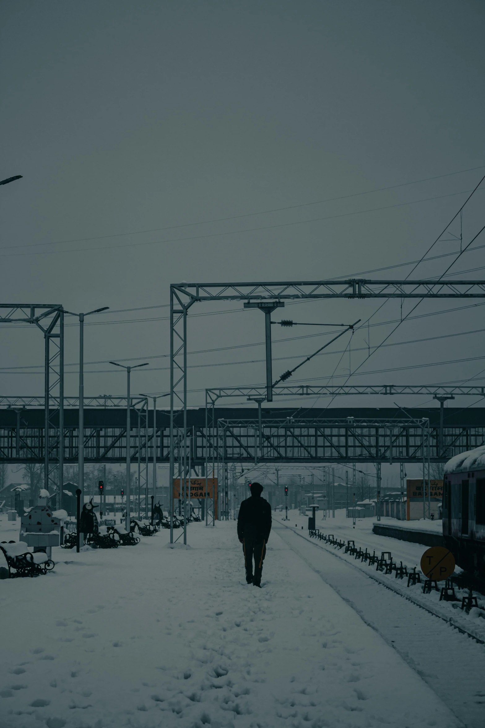 a man is walking up to the train in the snow