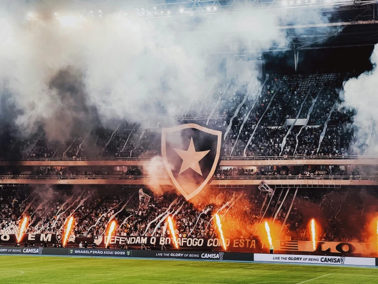 fireworks lit up behind a banner at a soccer game