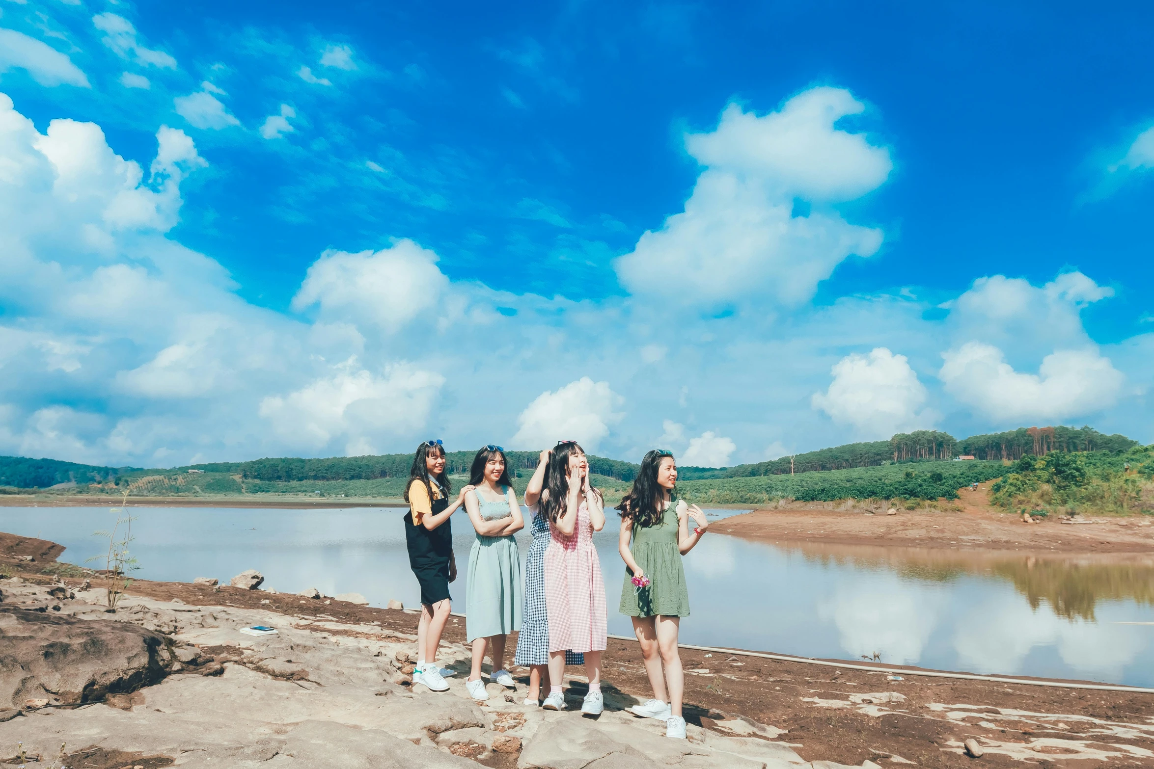 five women standing on the edge of a cliff posing for a po