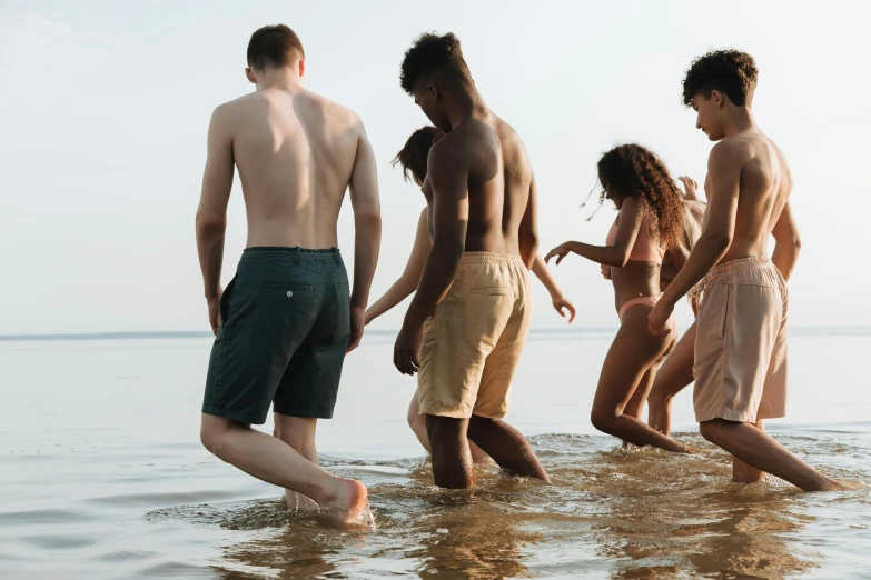 five men are standing in the water together