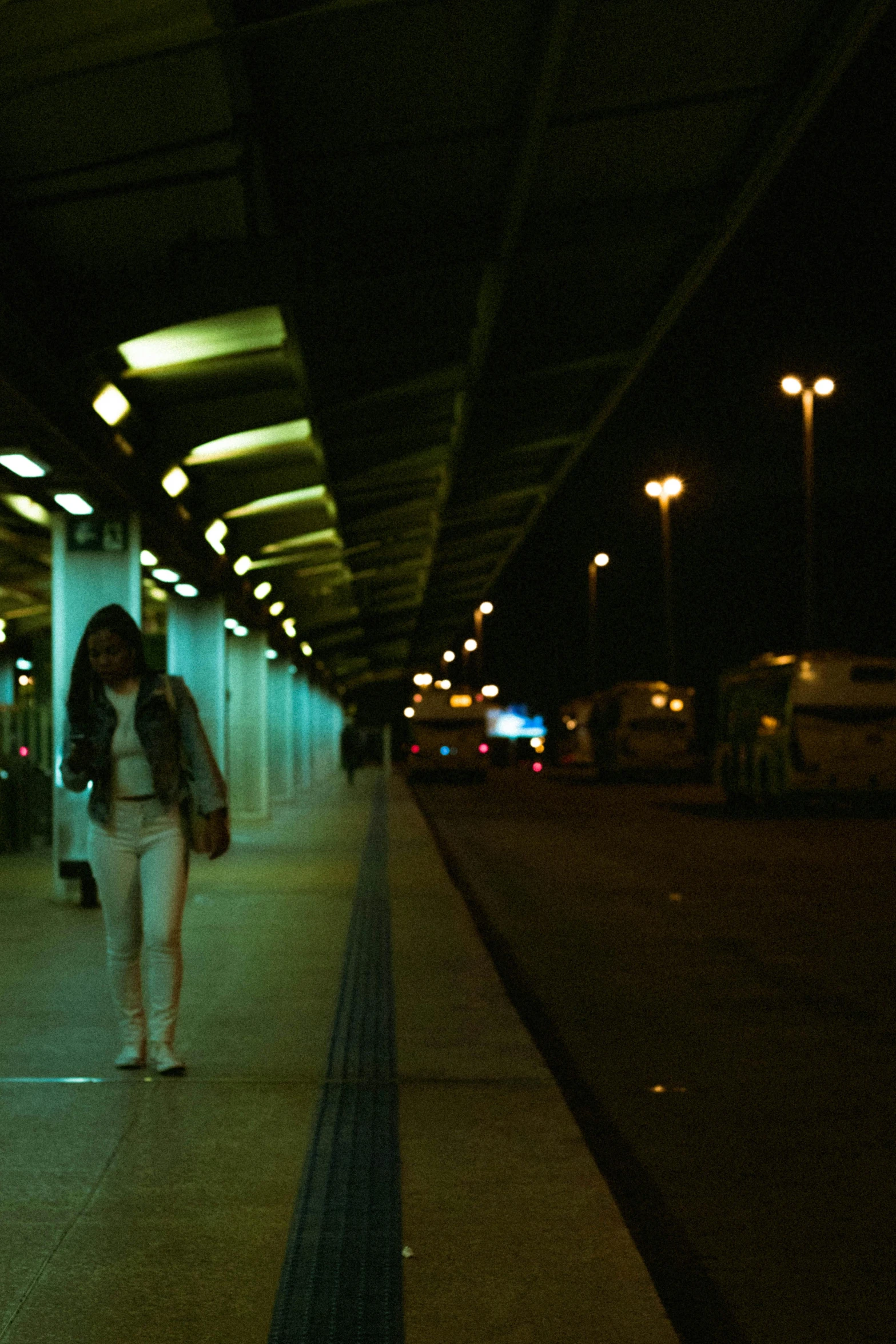 a person walking down the side walk on a sidewalk