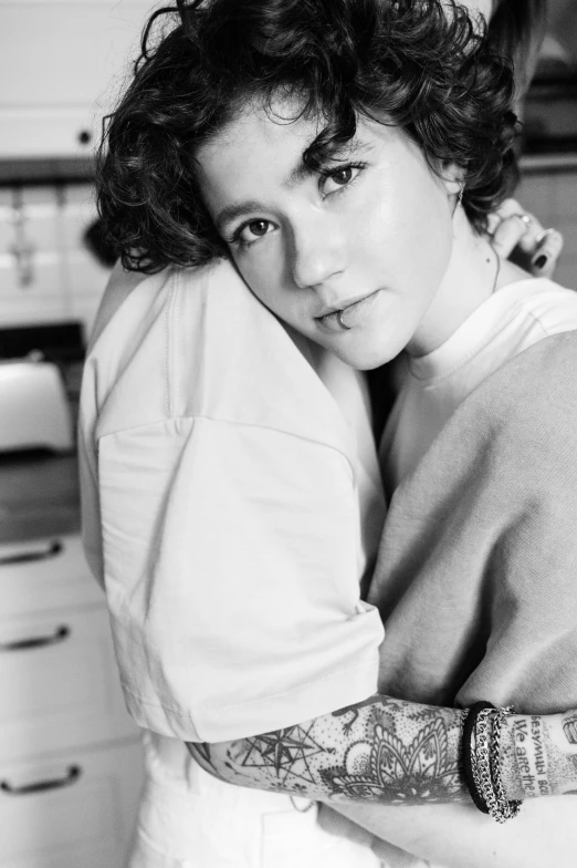 a woman standing next to a kitchen counter