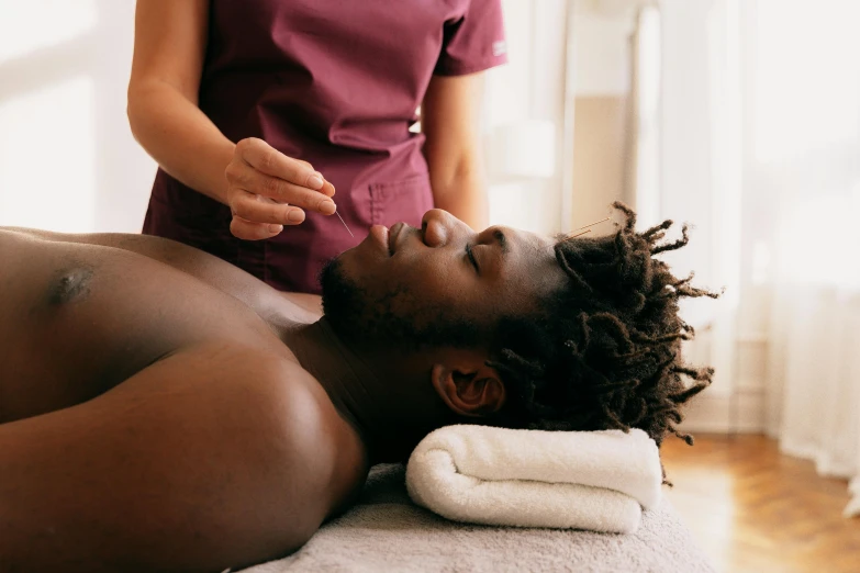 a man getting a facial massage from a hairdresser