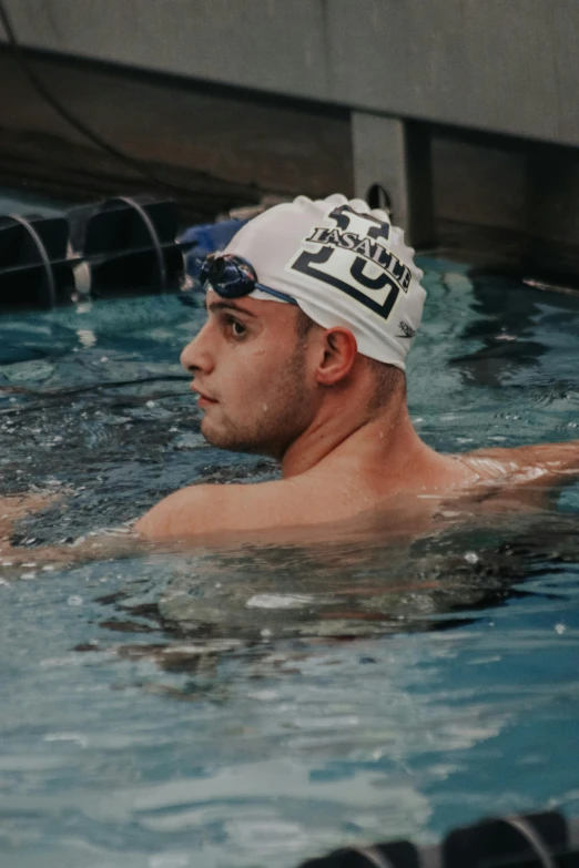 a man wearing a swimming cap in a swimming pool