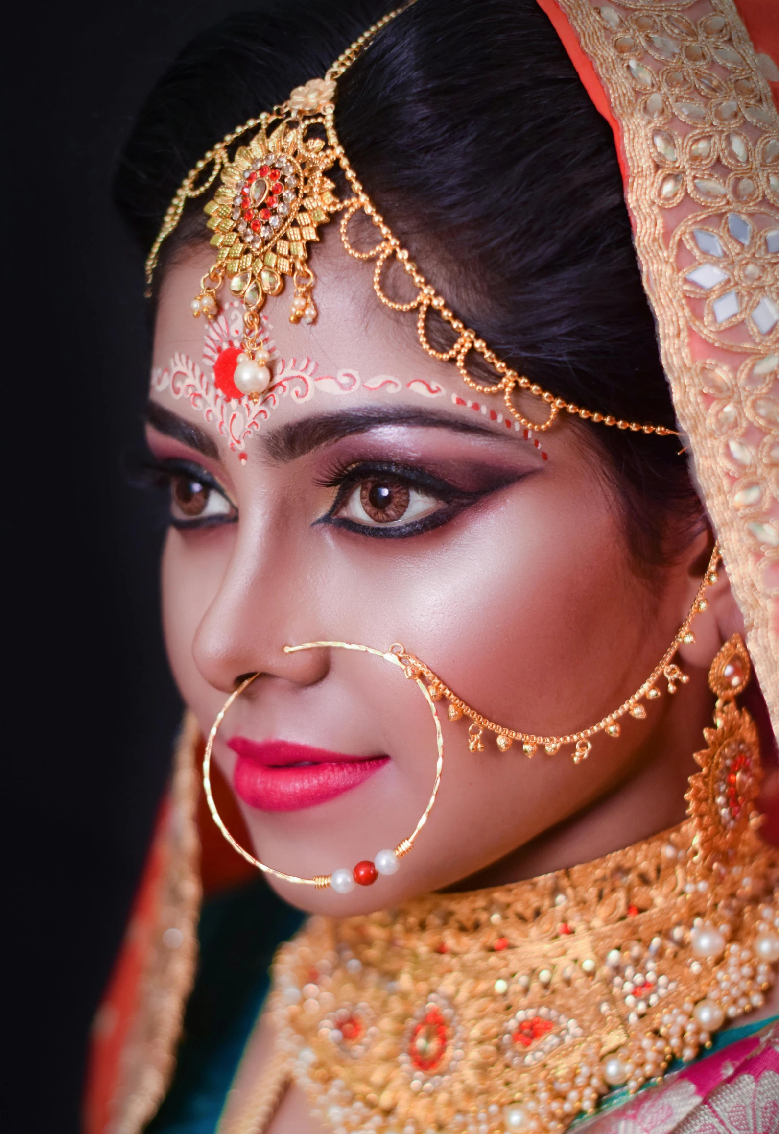 a beautiful woman wearing jewelry on her face