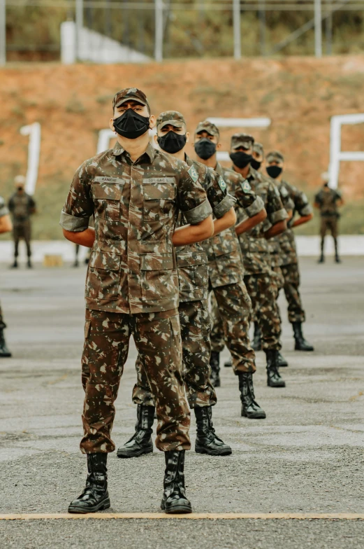 many people in military uniforms and masks stand in formation