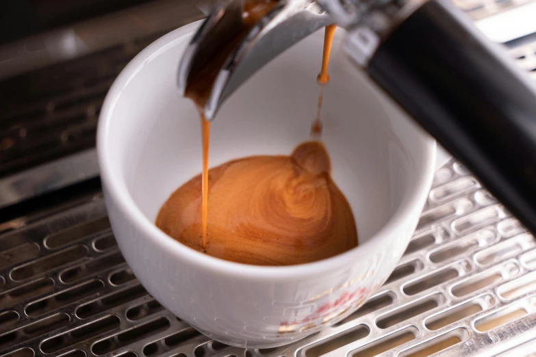 coffee being poured into a cup on a machine