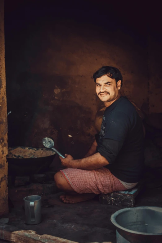 a man cooking food on a metal pan