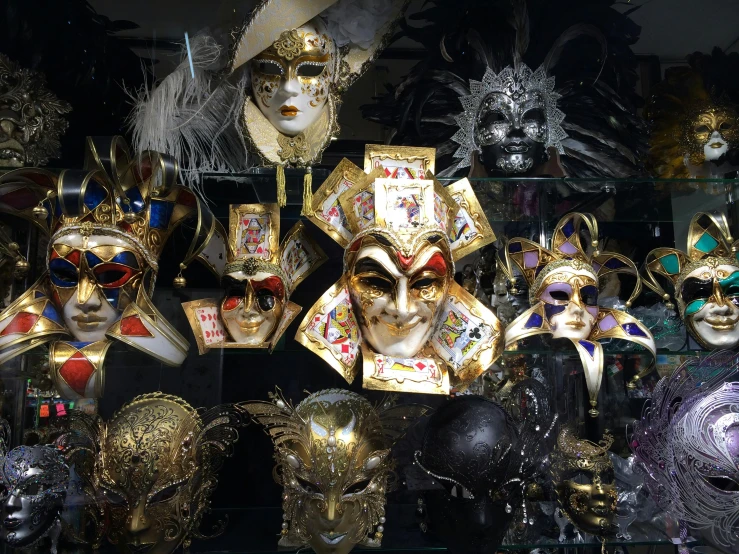 a storefront window displays many masks on display