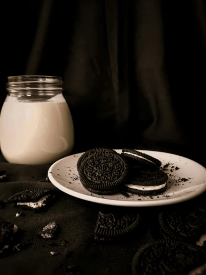 a white plate topped with cookies and a jar of milk