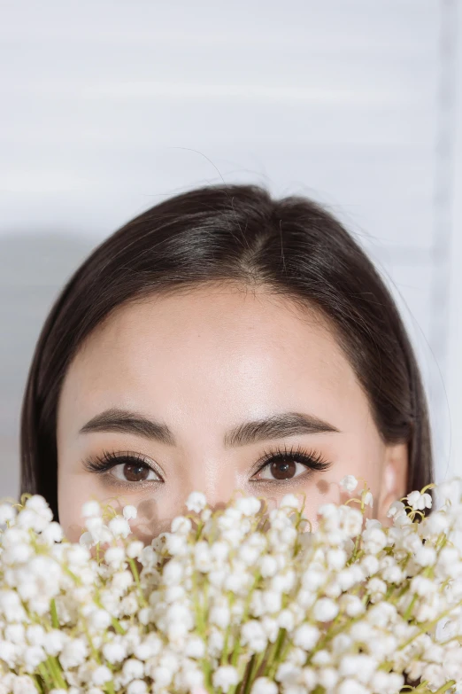 the girl is holding a bouquet of flowers