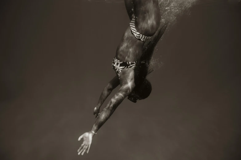 a man diving off the side of the boat