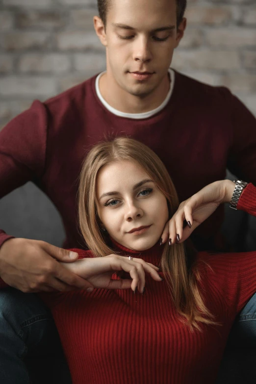 a boy and girl sitting down in the process of getting their hair done