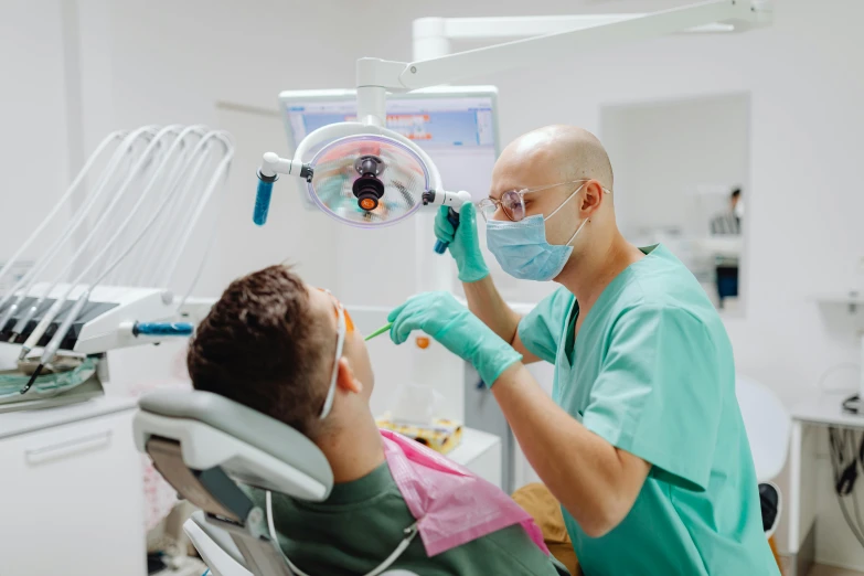 a dentist examining his teeth with a patient