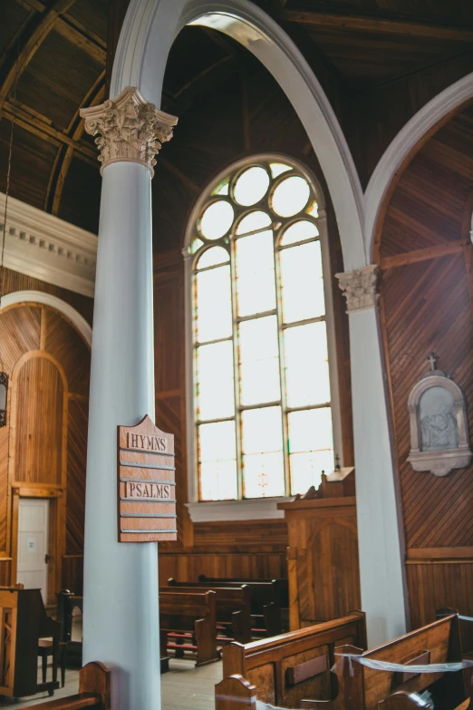 there are several windows above the pews